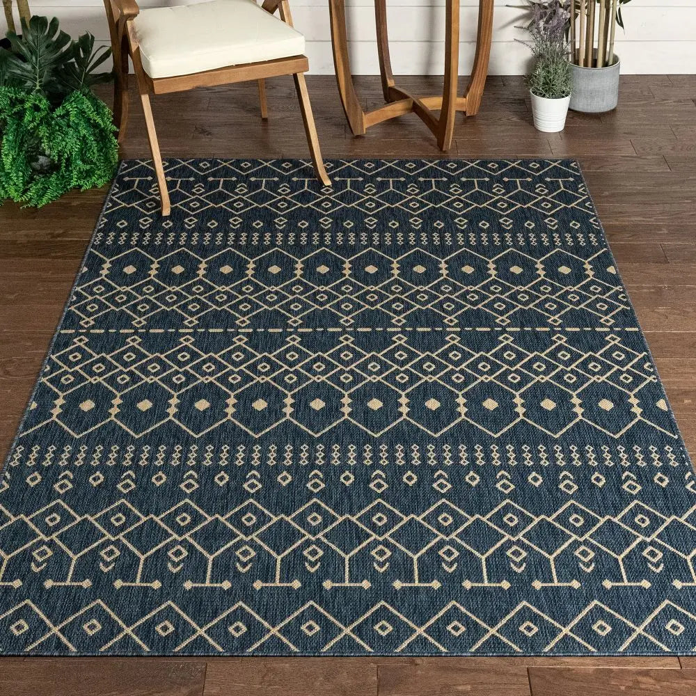 Nord Moroccan Tribal Indoor Outdoor Blue Flatweave Rug Well Woven - A blue moroccan rug placed under a dining table indoors, highlighting its transitional design and patterned symmetry.
